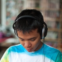 Tri wearing headphones focusing on work